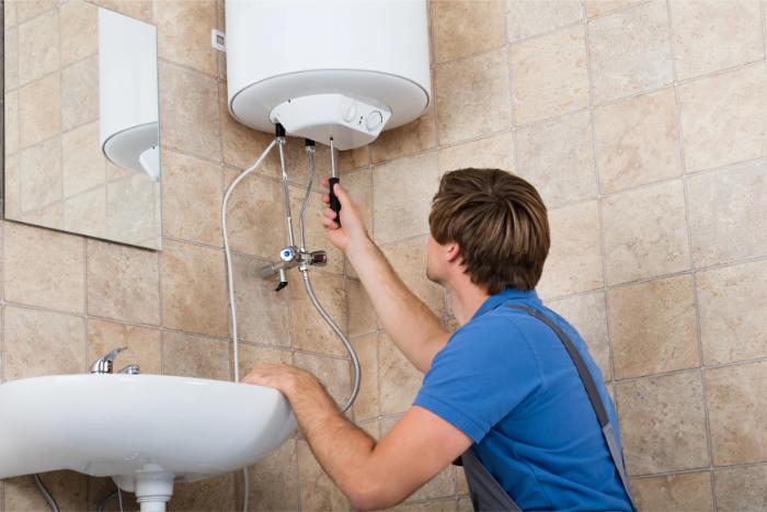 Technician fixing bathroom water heater