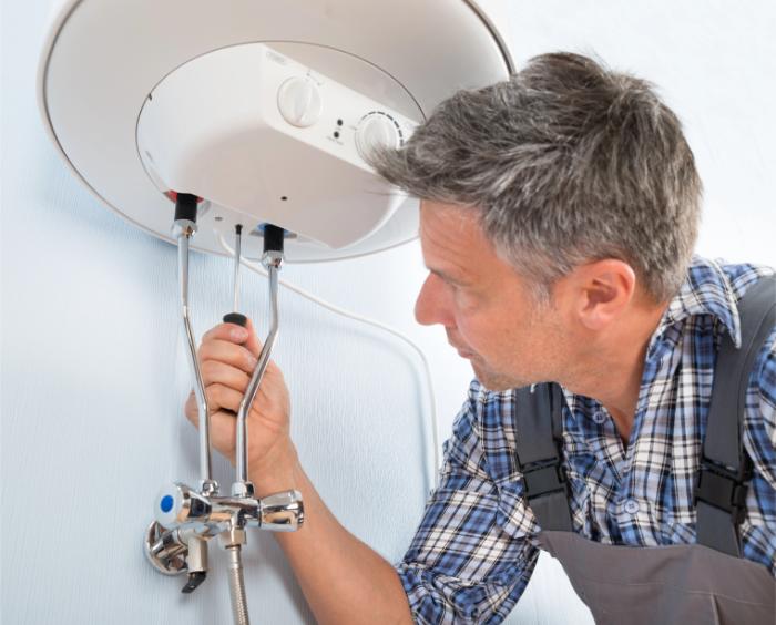 Technician adjusting plumbing connections