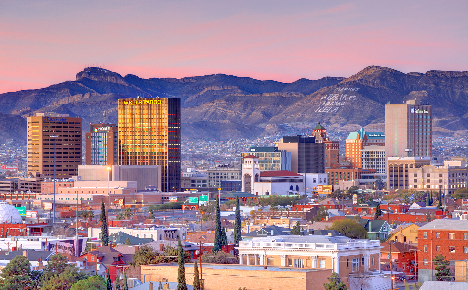 City skyline with mountains in the background.